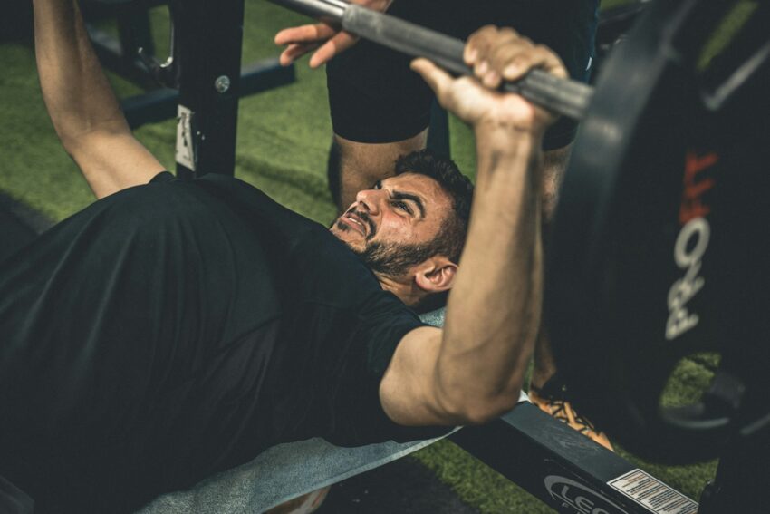 a man doing a bench press with a barbell